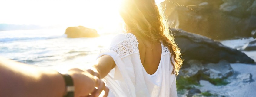 Couple on beach holding hands